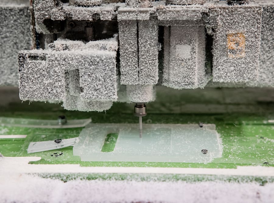 CNC machine milling an acrylic panel