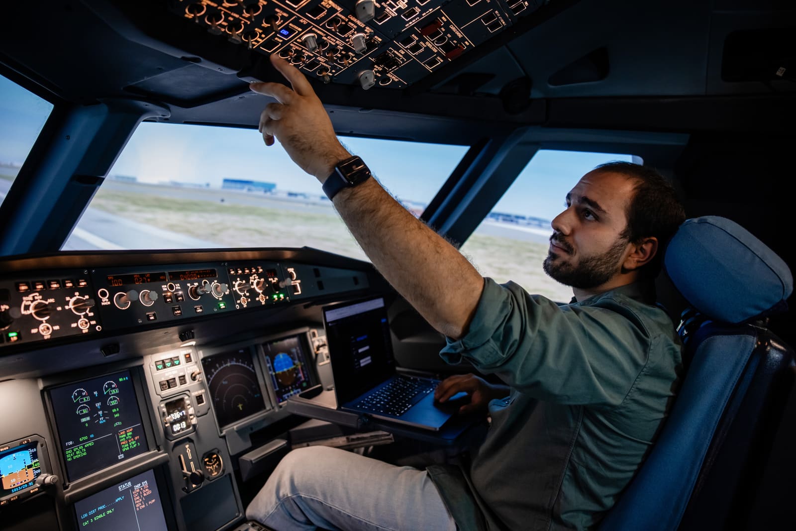 VOA engineer working on the overhead panel of an A320 simulator